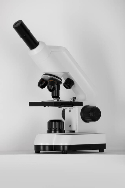 Modern microscope on light background. Medical equipment - Foto, Imagem