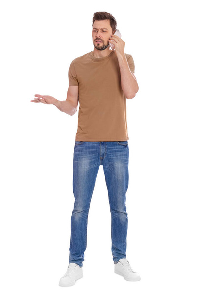 Man talking on phone against white background - Photo, Image