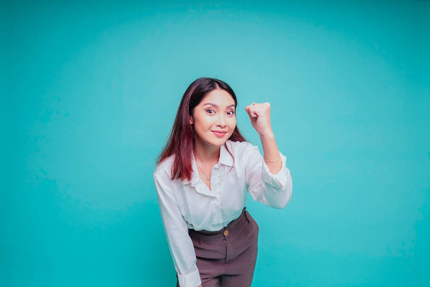 A young Asian woman with a happy successful expression wearing white shirt isolated by blue background - Foto, afbeelding