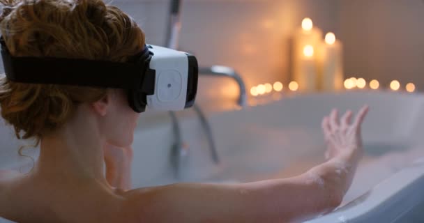 Virtual reality, bath and woman with bubbles water, candles and glasses for luxury lifestyle with 3d video gaming, show or movie experience. VR software, bathroom and spa of person hands in metaverse. - Footage, Video