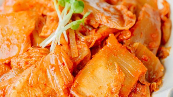 Kimchi ben fermentato mescolare-fritto con cipolla verde tritata e aglio in una padella unta con olio, questo è un contorno popolare di solito mangiato con riso. Va bene anche con la cagliata di fagioli.. - Foto, immagini