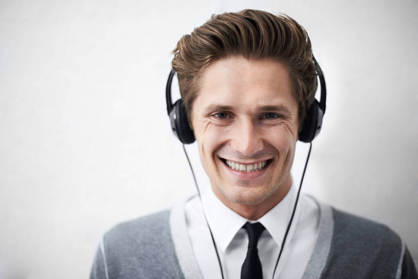 Music makes everything better. A handsome young man listening to music on his headphones - Foto, immagini