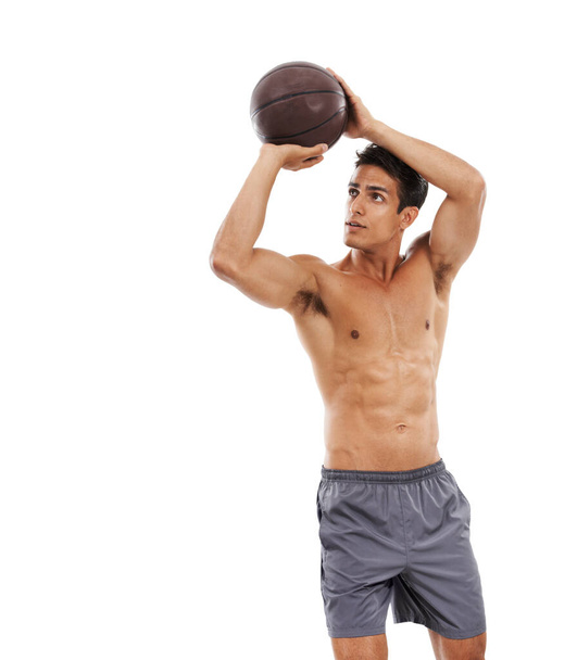 Working on his 3s. A shirtless sportsman shooting hoops against a white background - Copyspace - 写真・画像
