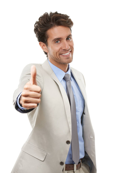 Im really impressed with you. Studio portrait of a handsome young businessman giving the thumbs up isolated on white - Фото, изображение