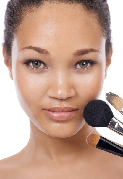 Finding the correct blush for application. Beauty portrait of a young womans face and 3 make-up brushes - Foto, Imagem