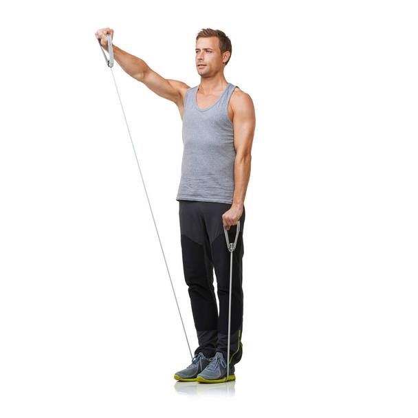 Perfect technique. A fit young man working out with a resistance band while isolated on a white background - Фото, зображення