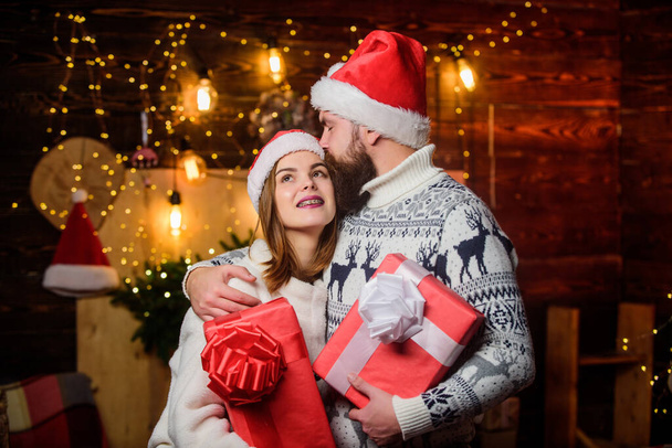 Surprise for dearest. Couple in love enjoy christmas holiday celebration. Family tradition. Christmas time. Loving couple cuddle christmas tree background. Romantic feelings. Winter romance. - Фото, изображение