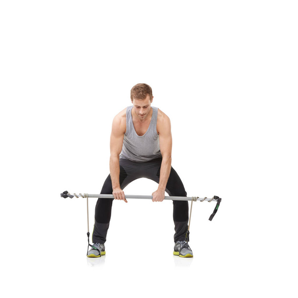 Maintaining a healthy lifestyle. A young man doing resistance training against a white background - Фото, зображення