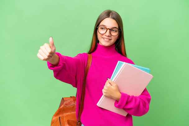 Teenager student caucasian girl over isolated background giving a thumbs up gesture - Fotografie, Obrázek