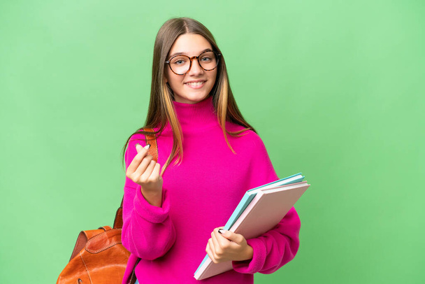 Teenager student caucasian girl over isolated background making money gesture - Valokuva, kuva