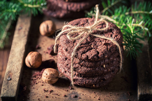 Homemade and tasty chocolate cookies made for Christmas Eve. Little cookies made of cocoa and nuts. - 写真・画像