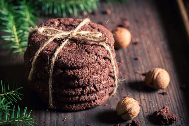 Sweet and brown chocolate cookies on rustic style. Little cookies made of cocoa and nuts. - Foto, afbeelding