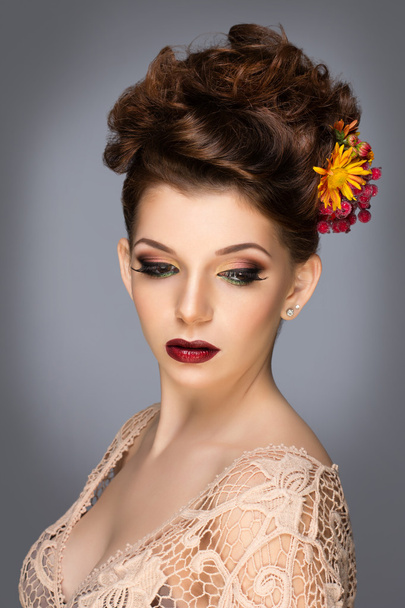 Beautiful woman with flowers. Perfect face skin. Beauty Portrait. Fashion photo. Fashion make up. - Fotó, kép