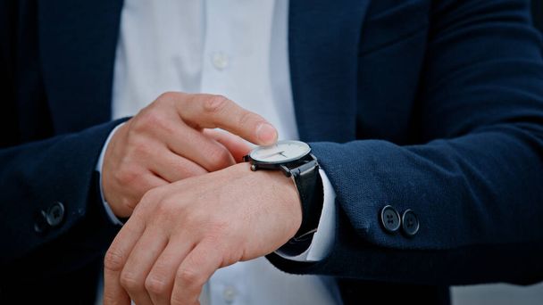 Cropped view closeup male hand with wristwatch clock Asian middle-aged businessman manager man male boss company CEO entrepreneur employer check time lateness waiting for meeting taxi in city outdoors - Φωτογραφία, εικόνα