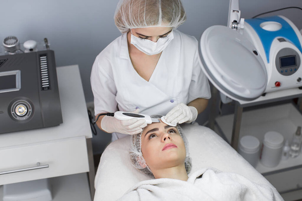 Skin Care. Close-up Of Beautiful Woman Receiving Ultrasound Cavitation Facial Peeling. Ultrasonic Skin Cleansing Procedure. Beauty Treatment. Cosmetology. Beauty Spa Salon. - Photo, Image