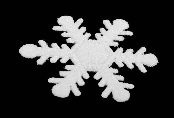 White snowflake isolated on black background. Detail for design. Design elements. Macro. Full focus. Background for business cards, postcards and posters. - Photo, Image