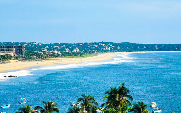 Beautiful natural panorama view with sea waves palm trees blue sky and beach in Zicatela Puerto Escondido Oaxaca Mexico. - Foto, immagini