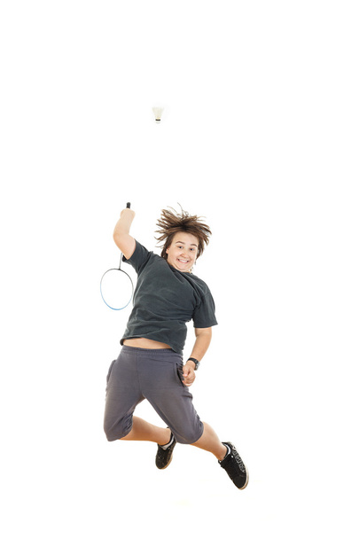boy holding badminton racket and trying to hit ball  - 写真・画像