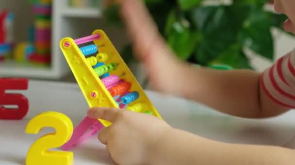A 5-year-old boy is learning to count on abacus, mathematics, arithmetic for preschoolers. - Footage, Video
