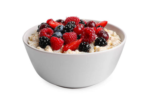 Bowl with tasty oatmeal porridge and berries on white background. Healthy meal - Photo, Image
