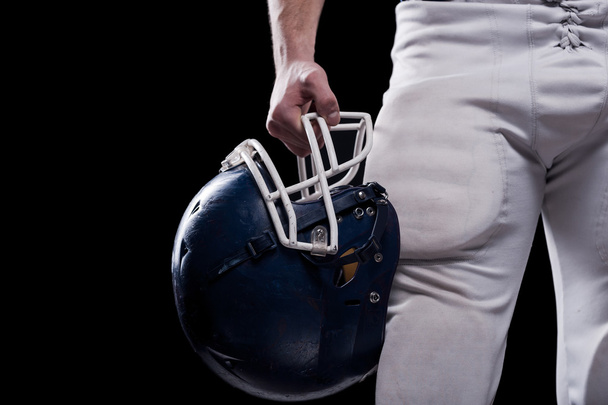American football player holding helmet - Фото, зображення