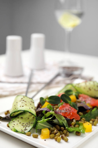 Plate of salad with mung beans on white table - Foto, afbeelding