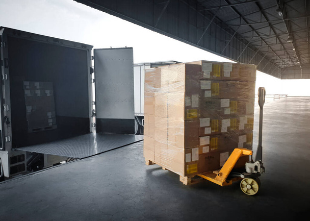 Packaging Boxes Stacked on Pallets Loading into Cargo Trucks. Shipping Trucks. Supply Chain Shipment Boxes. Distribution Supplies Warehouse. Freight Truck Transport Logistics. - Photo, Image