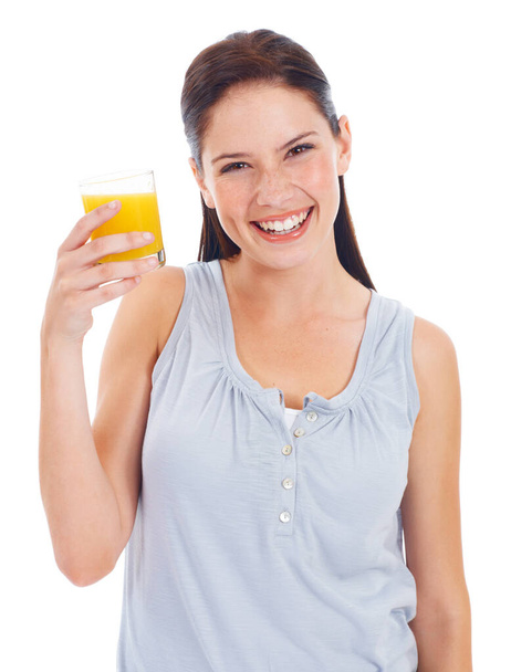 Fresh orange keeps her healthy. Pretty young woman isolated on white and drinking a glass of orange juice - Фото, изображение