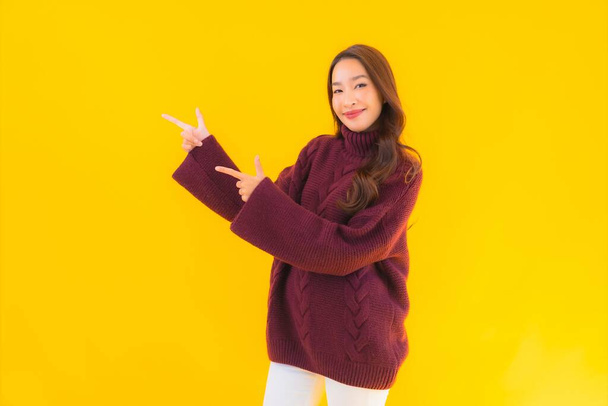 Portrait beautiful young asian woman smile happy in other action on yellow isolated background - Photo, Image