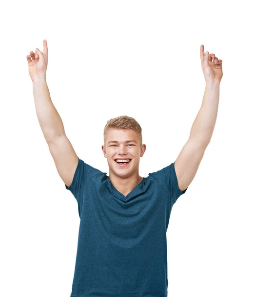 Success. A young man pointing to the skies while isolated on a white background - Foto, Imagen