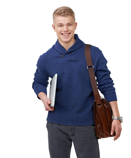 Hes ready for the new term. Portrait of a handsome young student standing with his satchel and notebook - 写真・画像