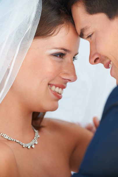 My world is a wonderful place with you in it. Closeup of newlyweds looking at one another with love - Photo, image