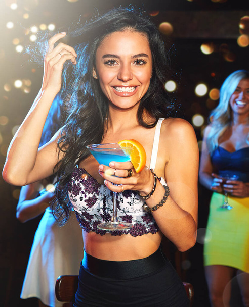 Woman, party and cocktail drink at nightclub, holiday celebration and new year portrait, happy ladies night and social. Celebrate, alcohol and drinking at club with happy hour and fruit cocktails. - Photo, Image