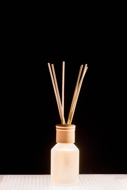 Fragrance for home. Aroma diffuser glass jar with aromatic liquid and bamboo sticks. - Foto, imagen