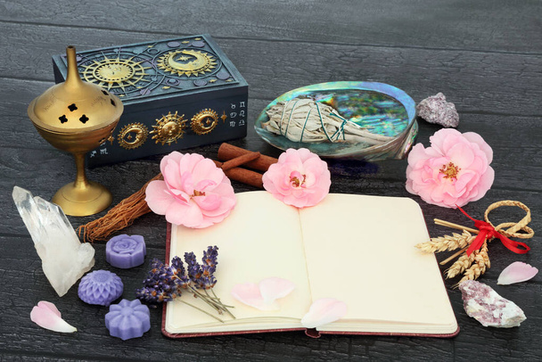 Crystal healing for fertility problems with recipe notebook, corn dolly, crystals, rose flowers herbs and purification equipment. Mystical, alternative, shamanic and Wiccan concept. - Photo, Image