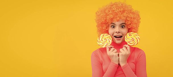 OMG. Surprised child hold lollipops. Lollipop fun. Childhood and girlhood. Try taste of sweet life. Funny teenager child on party, poster banner header with copy space - Photo, Image