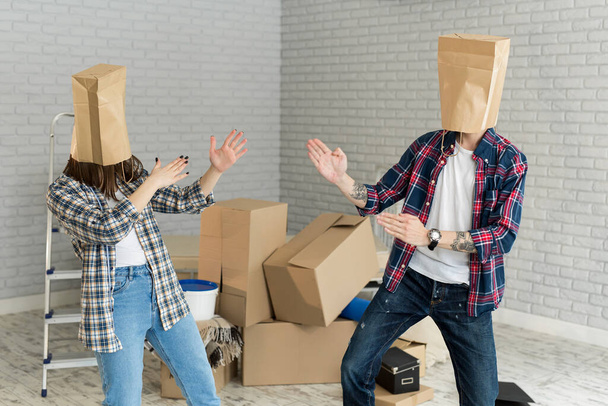 Couple With Cardboard Boxes On Their Heads - Foto, Imagen