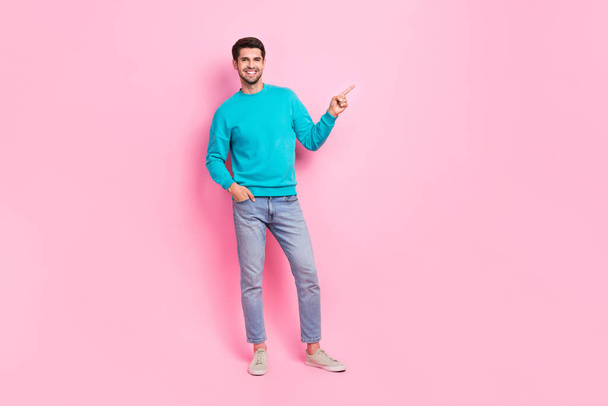 Full size photo of handsome young man finger point direct empty space dressed stylish blue clothes isolated on pink color background. - Фото, изображение