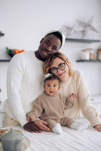 Mutfakta bebekleriyle mutlu ırklar arası aile portresi. Irklar arası aile kavramı ve farklı insan ırkları arasındaki birlik. - Fotoğraf, Görsel
