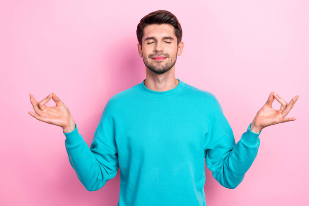 Photo of young handsome relaxed student guy wear blue pullover showing asana zen sign closed eyes after study isolated on pink color background. - Foto, afbeelding