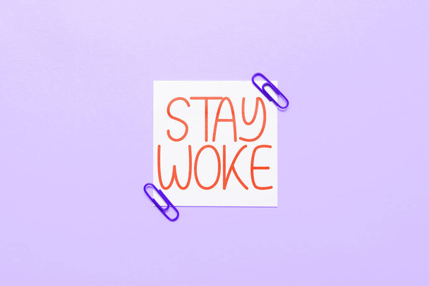 Schild mit der Aufschrift Stay Woke, Konzeptfoto, das sich seiner Umgebung und der Dinge, die vor sich gehen bewusst ist - Foto, Bild