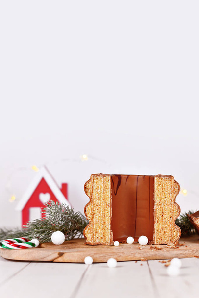 Open cake called 'Baumkuchen', a  German layered cake glazed with chocolate, surrounded by seasonal decoration - Foto, Imagen