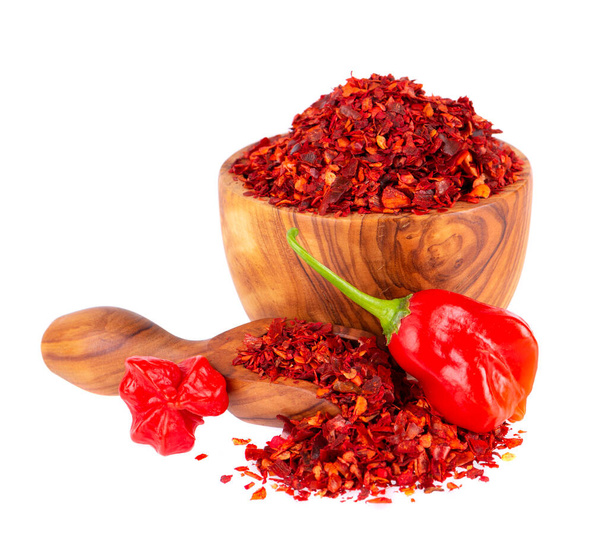 Fresh and dry ground red chili peppers isolated on white background. Capsicum baccatum or Bishops crown pepper - Photo, Image