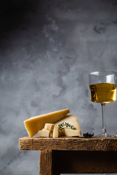 Parmesan cheese on a dark background close-up - Φωτογραφία, εικόνα