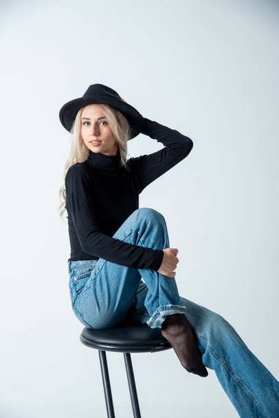 beautiful blonde woman posing with hat in studio - Fotoğraf, Görsel