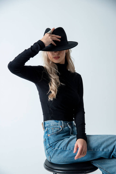 beautiful blonde woman posing with hat in studio - Zdjęcie, obraz
