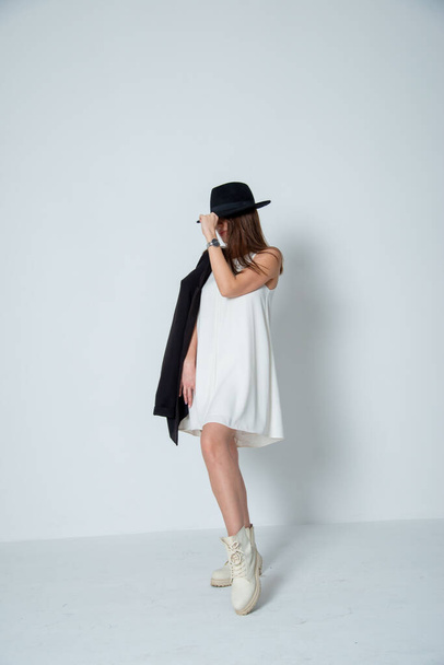 brunette woman posing in white dress and hat - Photo, Image