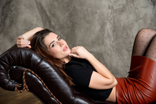 attractive sexy brunette girl posing on couch - Фото, зображення