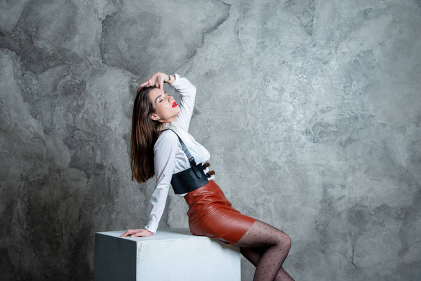 beautiful sexy woman posing in studio against gray wall - Zdjęcie, obraz