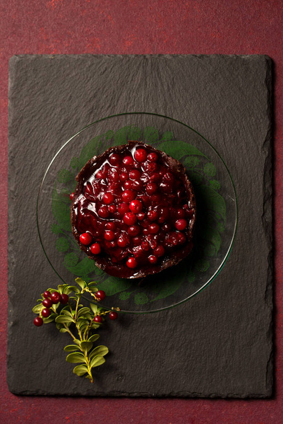 Chocolate dessert with delicious lingonberry jam on a burgundy background - Fotoğraf, Görsel